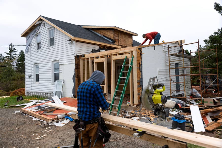 Storm damage restoration Huntington Beach crew assessing wind and rain damage to a property